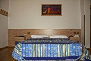 Voodi või voodid majutusasutuse Albergo Ristorante Iris toas