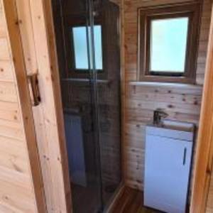 a bathroom with a shower and a sink at Fox Lodge at Heygates Lodging - with hot tub 