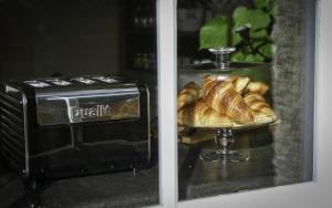 a toaster and a plate of croissants in a window at Moulton Lawn House B&B 