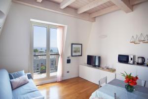 a living room with a couch and a large window at Sweet Sea View in Savona
