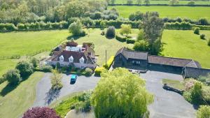 an aerial view of a large house in a field at Owls Nest - Peace and Tranquility near Woodbridge & Framlingham in rural Suffolk in Woodbridge