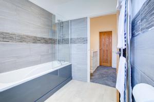 a bathroom with a glass shower and a sink at Pass the Keys Beautiful House in SouthChurch in Southend-on-Sea
