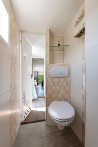a small bathroom with a toilet and a shower at 54, Prachtige natuur voor fietsers! in Oisterwijk