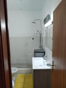 a bathroom with a sink and a toilet and a shower at Casa da laranjeira in Montargil