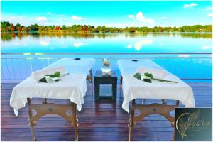 two tables on a boat with a view of a lake at House of Bell - Vaal River in Vanderbijlpark