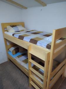 a bedroom with two bunk beds in a room at Vikendica Ribnik 