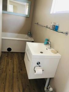 W łazience znajduje się biała umywalka i wanna. w obiekcie House of Bell - Vaal River w mieście Vanderbijlpark