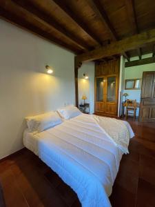a bedroom with a large white bed in a room at Posada El Valle - Adults Only in Suances