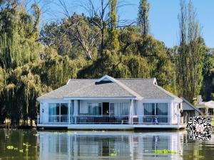 a house in the middle of a flooded street at House of Bell - Vaal River in Vanderbijlpark