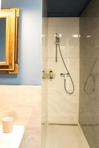 a bathroom with a shower with a glass door at Quiet apartment with a terrace on Organic farm in Prevalje