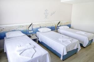En eller flere senge i et værelse på PEDASOS ALTINEL OTEL