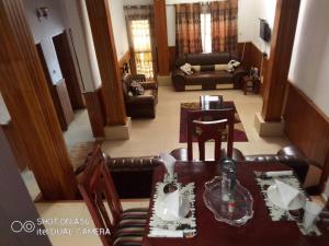 a view of a living room with a table and chairs at Villa le Dakota in Yaoundé