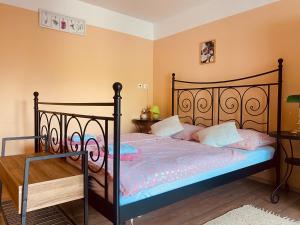 a bedroom with a bed with a black bed frame at Apartments Olga in Bled