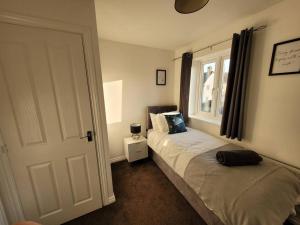 a bedroom with two beds and a window at Kensington House- The Perfect home for contractor stays in Colchester