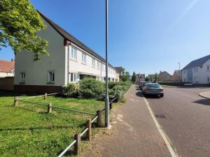 a house on the side of a street with a car at Kensington House- The Perfect home for contractor stays in Colchester