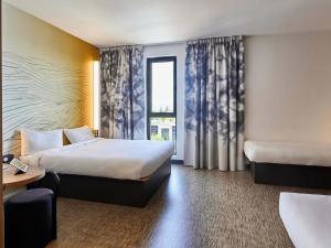 Postel nebo postele na pokoji v ubytování B&B HOTEL Argenteuil