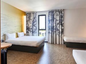 Postel nebo postele na pokoji v ubytování B&B HOTEL Argenteuil
