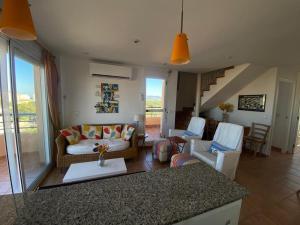 a living room with a couch and chairs at XimoApartments AP-6 ÁTICO DUPLEX CON VISTAS AL MAR Y PISCINA in Oliva