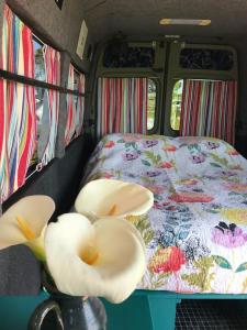 a campervan with a bed and a bed with a bed sidx sidx sidx at Berty the campervan in Carbis Bay