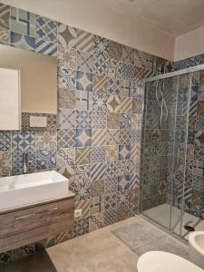 ein Bad mit einem Waschbecken und einer Dusche in der Unterkunft Charming apartment in center in Scicli