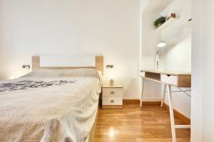 a white bedroom with a bed and a desk at Beferent San Juan Pueblo Centro in San Juan de Alicante