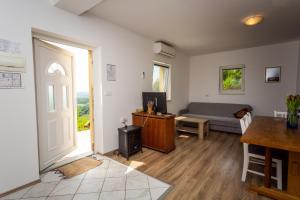 a living room with a couch and a door at Apartmani Cerovečki in Krapina