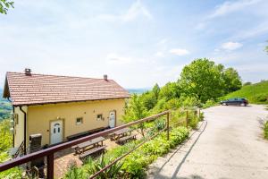 a building with a car parked next to a road at Apartmani Cerovečki in Krapina