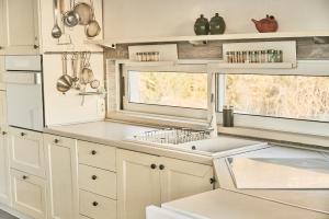 a kitchen with white cabinets and a sink at Mahakala Center in Petrovac na Moru