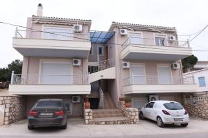 two cars parked in front of a house at Katerina luxury suites in Elia Laconias