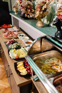 a buffet line with many different types of food at Palace Bulevard Inn in Cluj-Napoca