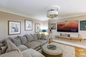 a living room with a couch and a table at Luxurious Brighton Apartment with Hot Tub in Brighton & Hove