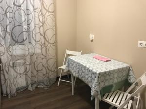 a room with a table and chairs and a curtain at Guest House Olzhycha 45 Б in Kyiv +12 photos