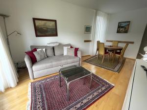 a living room with a couch and a table at Muralto-Locarno: Collina Apt. 32 in Muralto