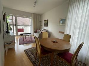 a living room with a table and a bedroom at Muralto-Locarno: Collina Apt. 32 in Muralto +13 photos