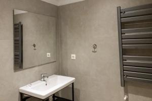a bathroom with a sink and a mirror at Elegant Apartment in Thessaloniki