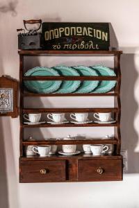 a wooden shelf with plates and cups on it at Villa Sofita in Pitsidia