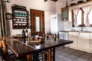 a kitchen with a table with a bowl of fruit on it at Villa Sofita in Pitsidia