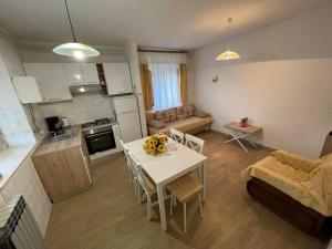 a kitchen and a living room with a table in a room at Apartment Felice in Novigrad Istria