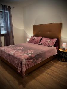 a bedroom with a bed with a pink comforter at Apartments Mestrovic, Klimno, Soline bay, island Krk in Klimno