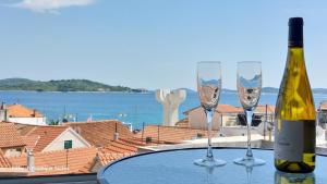 a bottle of wine and two wine glasses on a table at Refresh Boutique Suites - NEW in Vodice