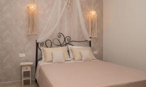 a bedroom with a large bed with white sheets and pillows at Beach House Lefkes A in Planos