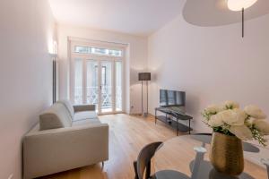 a living room with a couch and a table at Milan Royal Suites Duomo in Milan