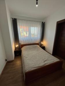 - une petite chambre avec un lit et une fenêtre dans l'établissement DOM POD WIŚNIĄ, à Giżycko