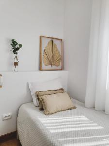 1 dormitorio con 1 cama con una foto en la pared en Casa dos Avos en Ovar