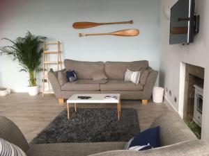 a living room with a couch and a coffee table at The Bolthole in Limekilns
