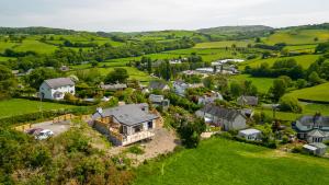an aerial view of a house in a green field at Ty Uchaf Cottage in Llansantffraid Glan Conwy