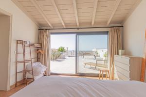 a bedroom with a bed and a view of a patio at El Drago in Manilva