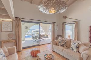 a living room with a couch and a table at El Drago in Manilva