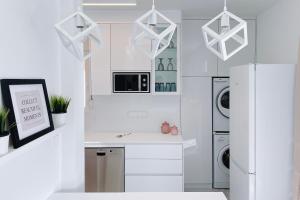 a kitchen with white appliances and a white refrigerator at Euphoria luxury penthouse in Kavala