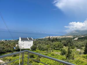 a view from the balcony of a house with the ocean in the background at Season Inn in Dhërmi +84 photos
